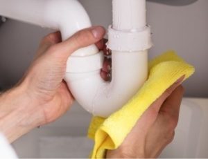 Emergency plumber repairing leaking sink pipe near Miamisburg OH